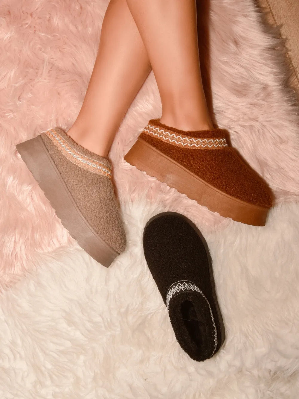 Model wearing embroidered sherpa platform boots with winter outfit